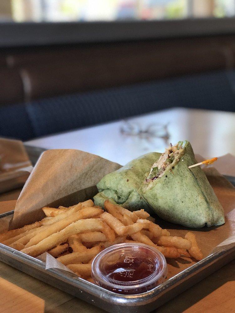 Chicken Caesar Wrap · Grilled chicken breast, romaine lettuce, croutons, Parmesan, Roma tomato, Caesar dressing and tomato basil wrap. With choice of side.