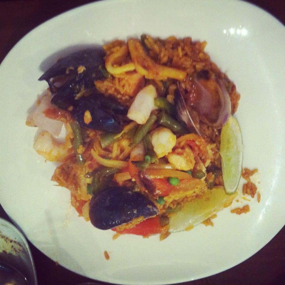 Paella Valenciana · A delicious mix of meat and seafood, prepared with shrimp, squid, fresh mussels, clams, fish & chicken.