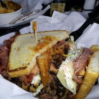 The New Yorker · Over 3/4 lb. of our pastrami and corned beef served on rye bread with Swiss cheese, Russian ...