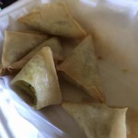 Samosas · Fried pastry with peas and spices and a choice of seasoned beef or potato filling. Served wi...