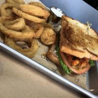 Nashville Chicken Sandwich · Breaded chicken, house hot sauce, lettuce, tomato, banana peppers, jalapeño cream, and jalap...