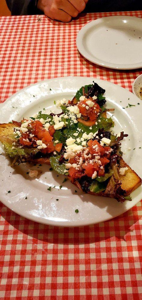 Bruschetta · A combination of fresh chopped tomato, capers, Kalamata olives, fresh basil and garlic, mixed greens and olive oil served on sliced sourdough topped with feta cheese.