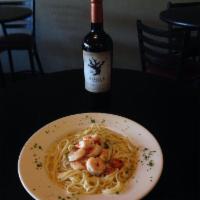 Shrimp Scampi · Sautéed shrimp in a spicy, garlic butter sauce with tomatoes, served over linguini.