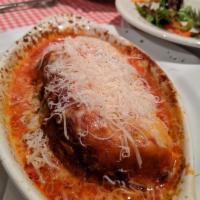 Lasagna Bolognese · Homemade 4-layer meat lasagna served with a creamy marinara.