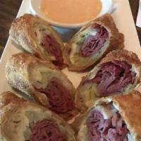 Irish Spring Rolls · Wontons stuffed with lean corned beef, cabbage and Swiss cheese, served with a side of Thous...