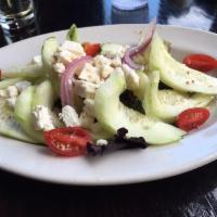 Cucumber Salad · Cucumbers, tomatoes, onions, feta cheese, and red wine vinaigrette on a bed of mixed greens....