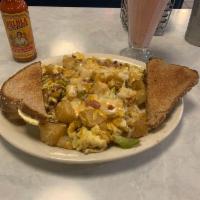 Blue Moon Scramble · Ham, bacon, sausage, green pepper, onion, cheddar cheese and swiss cheese.

