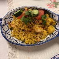 Pineapple Fried Rice · Fried rice with shrimp and chicken, onion, cashew nuts, raisins and pineapple.