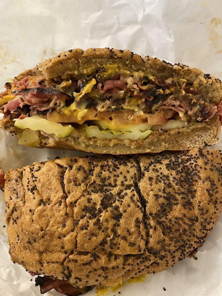 Chicago Pastrami · Tender, juicy pastrami stacked high on our poppy seed bun served with melted pepper jack and cheddar cheese, tomato, pickle, pepperoncini, grilled onions and mustard.