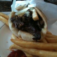 Lamb Gyro · Slow roasted rotisserie lamb. Served in pita bread with tzatziki sauce, tomato and onions.