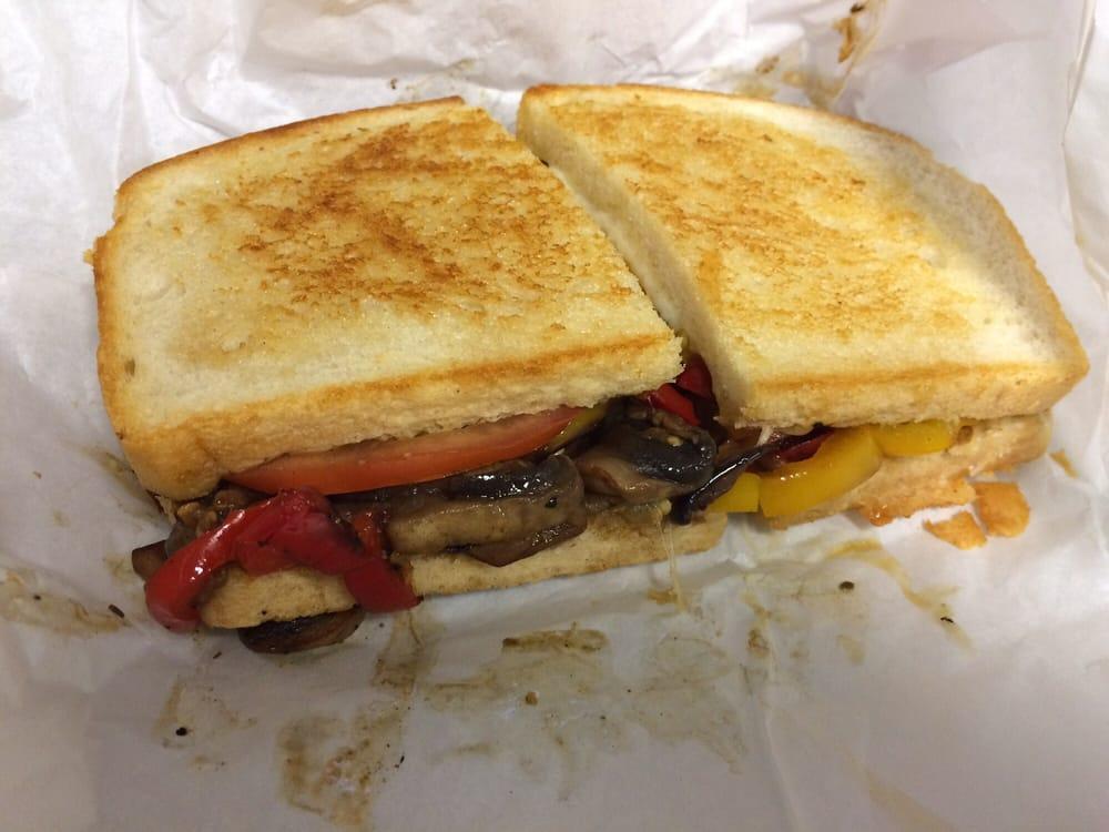 Hot Vegetarian Sandwich · Roasted eggplant, peppers and mushrooms with freshly sliced tomatoes, topped with Parmesan cheese served on grilled sourdough.