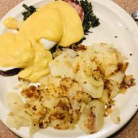 Eggs Benedict · Served with home fries and topped with hollandaise sauce. Two poached eggs with Canadian bac...