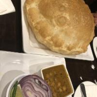 Chole Bhature · Big fluffy deep fried Indian bread served with Punjabi style spicy chick peas masala.