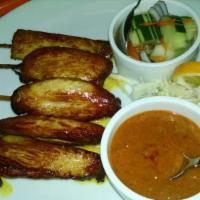 Chicken Satay · Charbroiled chicken on skewers served with peanut sauce and cucumber salad.