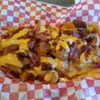 Totchos · Tater tots topped with beef chili, cheese sauce, chopped smoked bacon, pickled at jalapenos ...