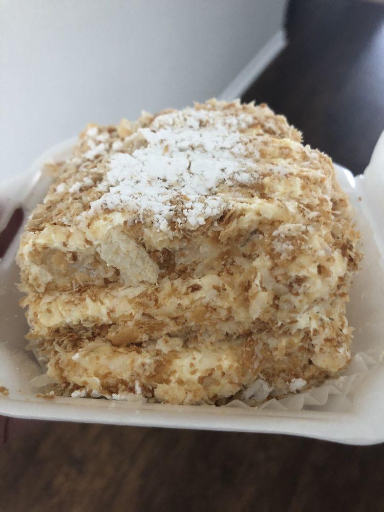 Napoleon · French dessert consists of several, flaky and crispy layers of puff pastry filled with thick layers of angel cream, covered in powdered sugar.