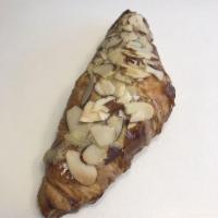 Almond Croissant · Freshly baked butter croissant filled with almond cream and topped with sliced almonds.