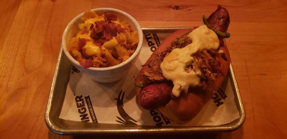 Chorizo Mac and Cheese Bratwurst · Beer-poached Hoptinger bratwurst, chorizo mac and cheese, layered with bacon strips and Jon Boat bacon mustard. Yes. We put chorizo mac and cheese on a dog. You're welcome.