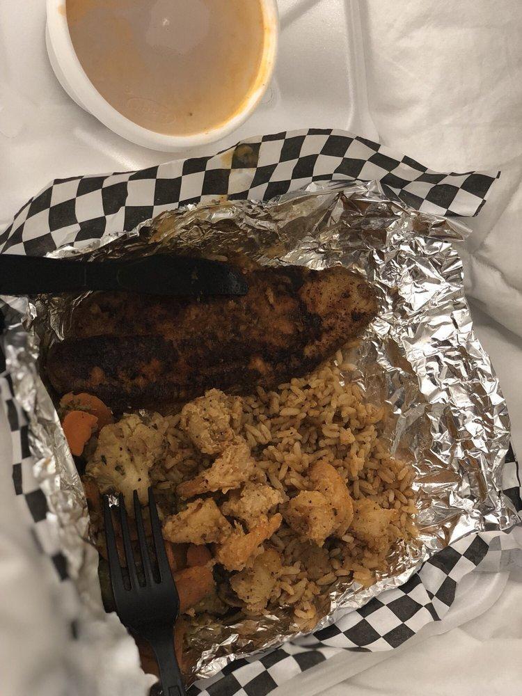 Catfish Opelousas · 2 blackened fillets, topped with etouffee and fried shrimp, served with dirty rice and mixed vegetables.
