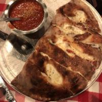 Calzone · Served with red sauce on the side.