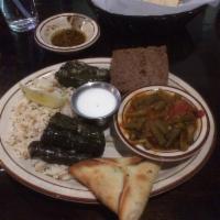 Traditional Combo · 1 fatayer, 1 baked kibbeh and 6 rolled grape leaves. Served with rice and green beans.