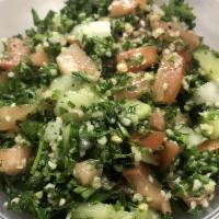 Tabbouleh Salad · Finely chopped parsley, diced tomato, cucumber, onions and bulgar wheat. Vegetarian.
