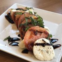 Caprese Salad · Thick-sliced tomatoes topped with fresh mozzarella cheese, basil and drizzled with extra vir...
