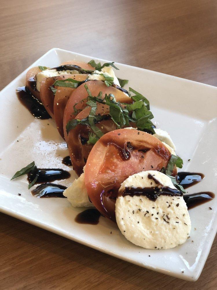 Caprese Salad · Thick-sliced tomatoes topped with fresh mozzarella cheese, basil and drizzled with extra virgin olive oil and balsamic glaze.