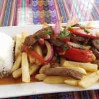 Lomo Saltado · Beef tenderloin slices, sauteed with onions, tomatoes, aji and other spices. Served with fre...