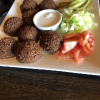Falafel Plate · 8 pieces of falafel served with tahini sauce, tomatoes, pickles and lettuce.