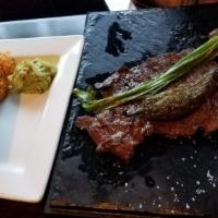 Carne Asada · Certified Angus beef skirt steak cooked to perfection. Served with green onion, fried jalape...