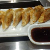 Gyoza · 6 pieces. Pan-fried pork dumplings.