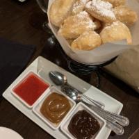 Pan Dulce · Light warm beignets dusted with powdered sugar served with dulce de leche caramel and milk c...