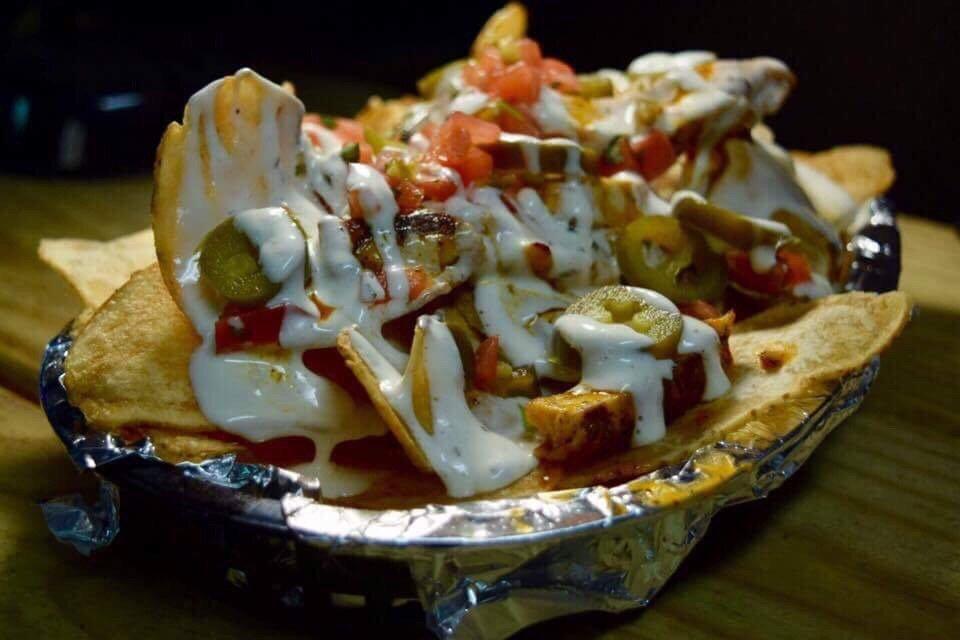Buffalo Chicken Spuds · Grilled chicken tossed in texas pete mild sauce on top of your choice of french fries, tater tots, or fresh chips topped with queso, salsa fresco, jalapenos, and ranch dressing.