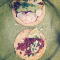 Al Pastor Tacos · Adabo marinated pork a la plancha with classic toppings. 2 tacos.