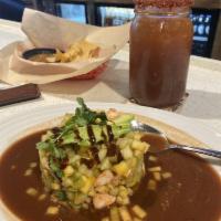 Tropical Tostada · Chopped cooked shrimp mixed with cucumber, mango marinated in our spicy hot sauce, topped wi...