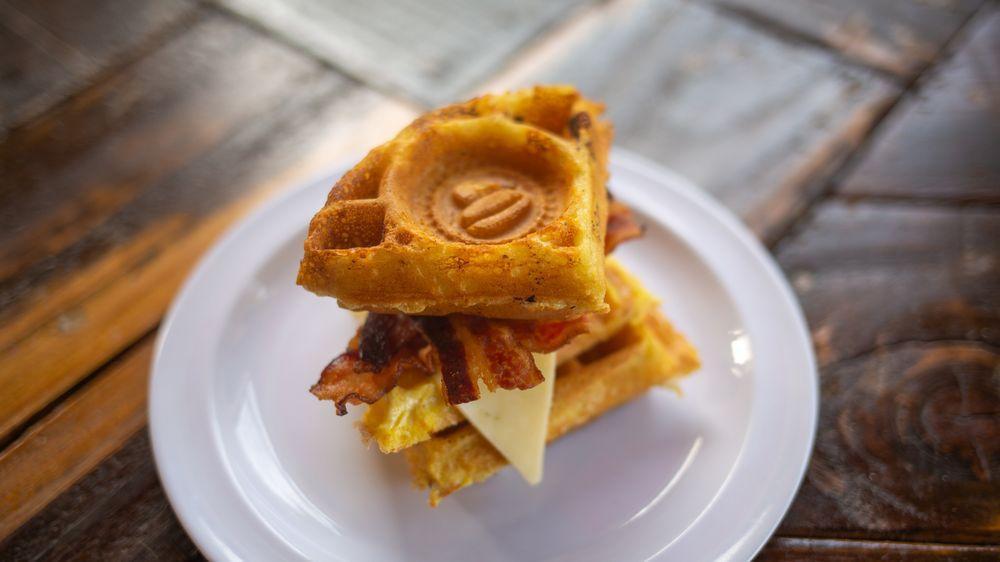 Breakfast Slider · Egg, pepper jack cheese, and your choice of sausage or bacon—all sandwiched between two traditional waffles and served with a side of maple syrup.