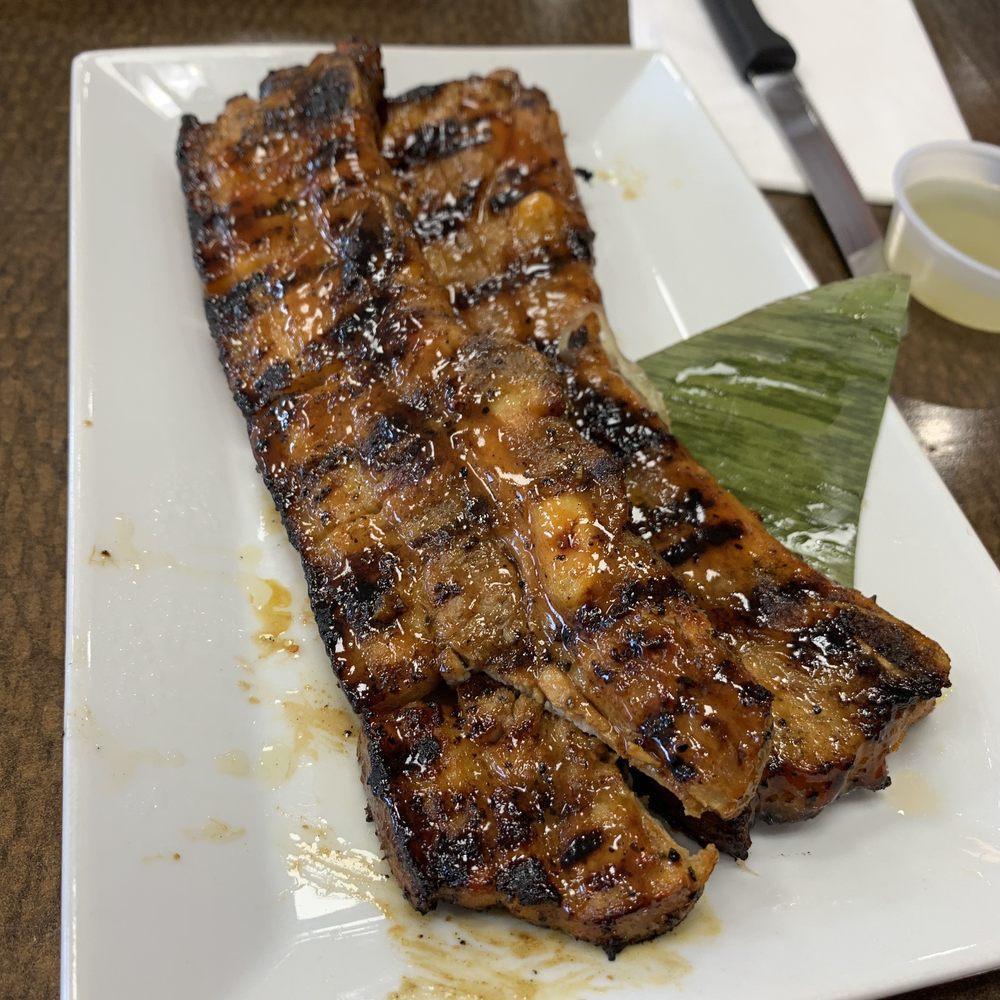 Grilled Pork Belly · Sliced bone-in pork belly marinated with our house blend spices and grilled to perfections. Served with our house-made pickled papaya slaw.