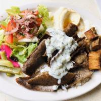 Gyro Plate · Beef and lamb mix topped with tzatziki sauce. Includes salad, hummus, garlic paste, potatoes...