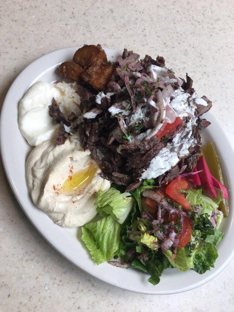Beef Shawarma Plate · Topped with tomatoes, onions and tahini sauce. Includes salad, hummus, garlic paste, potatoes, pickles, turnip, pita bread and rice.