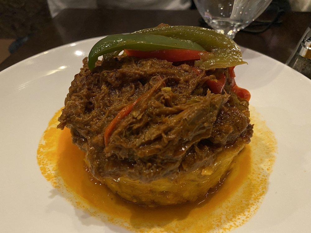 Ropa Vieja · Literally means old clothes. A Cuban classic .Braised shredded beef simmered with tomatoes, bell peppers, olives & sherry wine