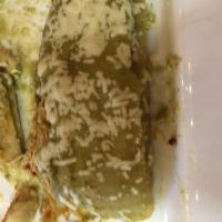 Tamales · 2 homemade tamales filled with tinga and topped with tomatillo.