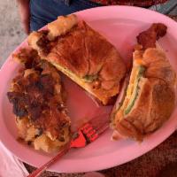Breakfast Croissant Sandwich · 2 over-hard eggs, your choice of meat (ham, sausage or bacon), American cheese, and mayonnai...