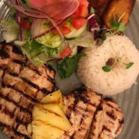 Pollo a La Plancha · Boneless chicken breast marinated in homemade pineapple juice topped with pineapple pieces s...
