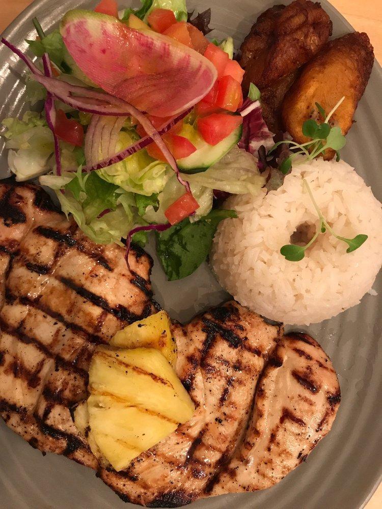 Pollo a La Plancha · Boneless chicken breast marinated in homemade pineapple juice topped with pineapple pieces served with plantain slices and salad.