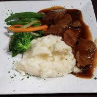 Brisket · Fork tender certified Angus beef in a pan gravy served with mashed potatoes and mixed vegeta...