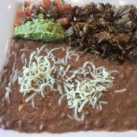 Carnitas Plate · Served with rice, beans, guacamole, pico de gallo, and choice of tortillas.