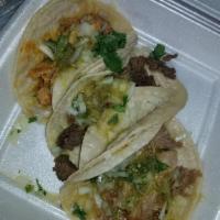 Carnitas Tacos · Served with salsa, onions, and cilantro.