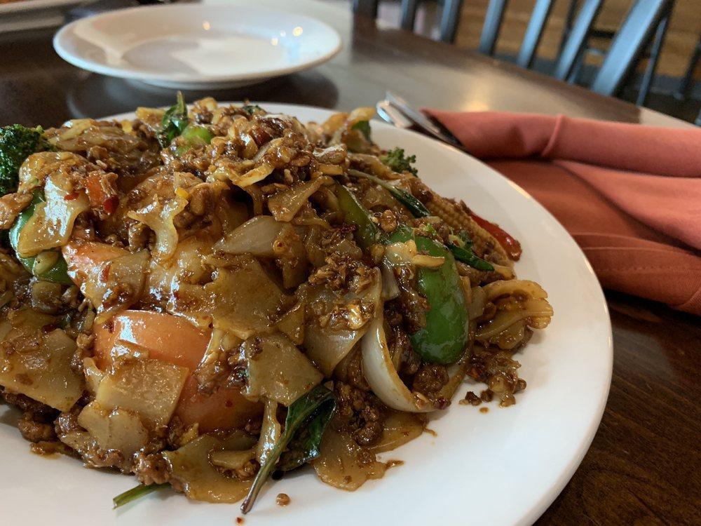 Pad Kee Mow · Minced meat. Flat noodles, egg, white onions, tomatoes, bell peppers, basil, broccoli, and jalapenos. Recommend ordering one spice level lower than usual.