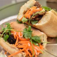 Grilled Pork Sandwich · Marinated pork, cucumber, cilantro and pickled carrots.